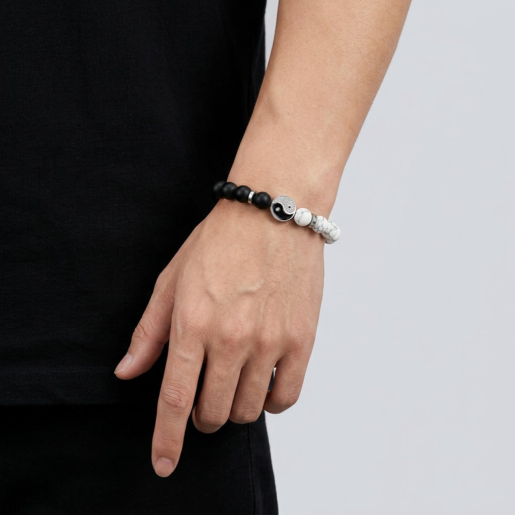 A symbol of balance and harmony, this bracelet blends contrasting tones into a sleek, meaningful design. With its black and white beads centered around the iconic yin-yang motif, it reflects a calm, balanced energy that feels both modern and timeless.
